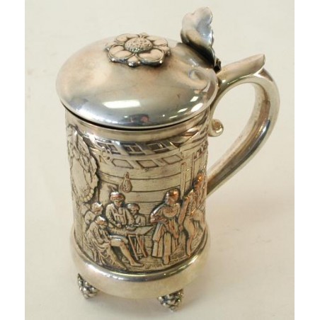 German Tankard in high relief depicting an interior of a tavern with people in 18th century dress celebrating. (Silver plate and (cur207)