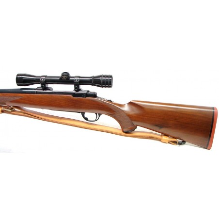 Ruger M77 .243 WIN caliber rifle. Early model with tang safety. Excellent condition with Redfield 4x scope and leather sling. (R14243)